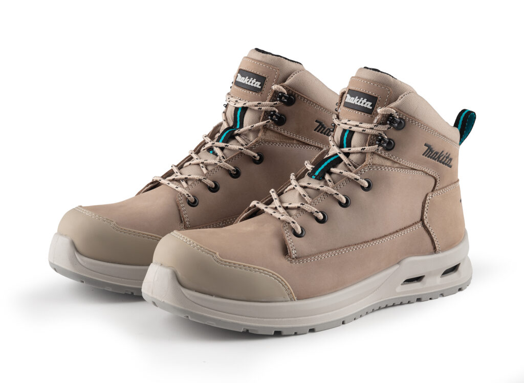 Tan hiking boots with beige laces and teal accents, close-up of the upper and eyelets.