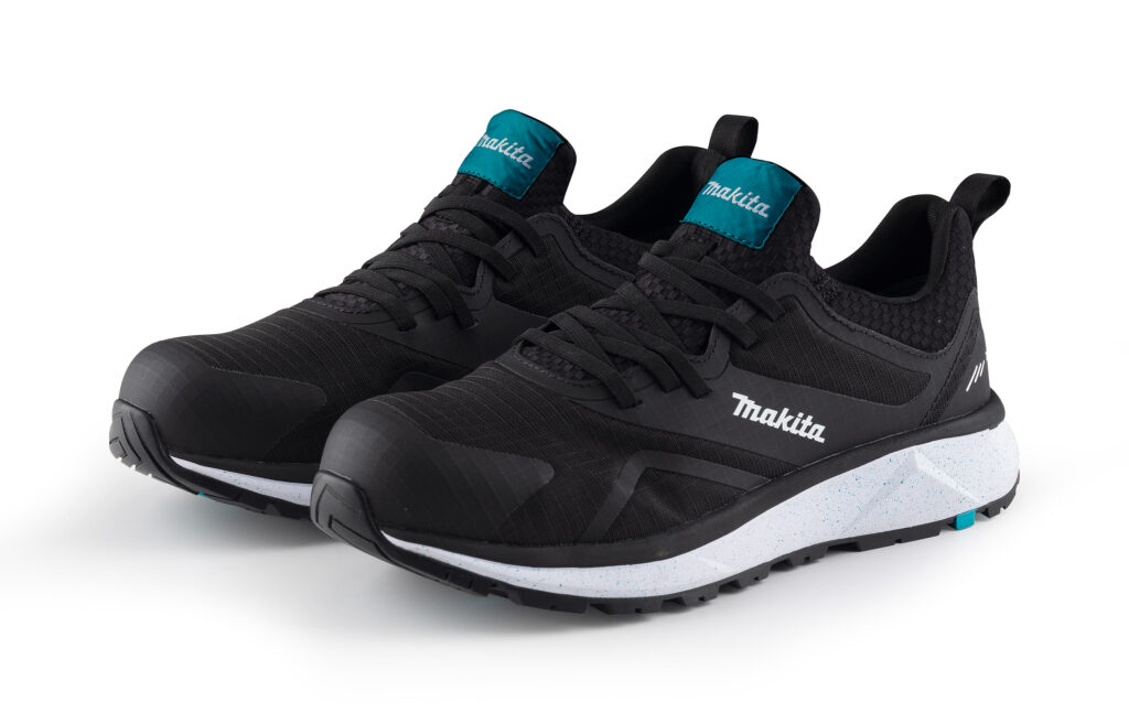 Black Makita athletic sneakers with teal tongue tabs and speckled white sole.