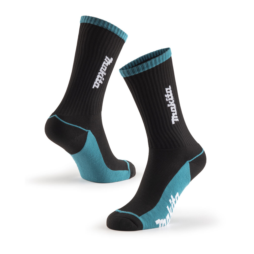 Pair of black athletic socks with teal cuffs and heels, photographed midair against a white background.